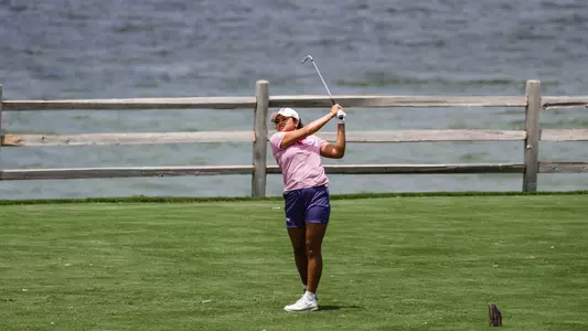Kirstin Angosta follows through and tracks her ball following a tee shot.