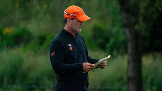 Greg Robertson looks over a golf pin sheet during a tournament.