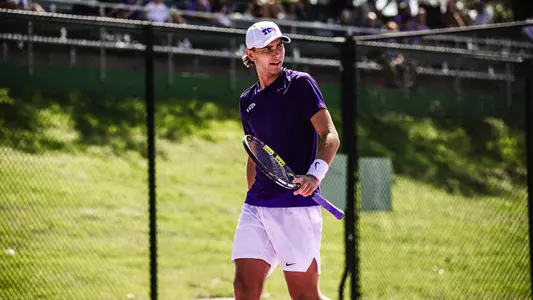 Cooper Woestendick reacts to winning a point wearing a purple shirt