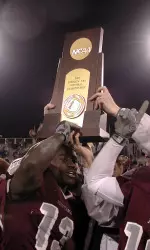 Calvin Coleman hoists the championship trophy