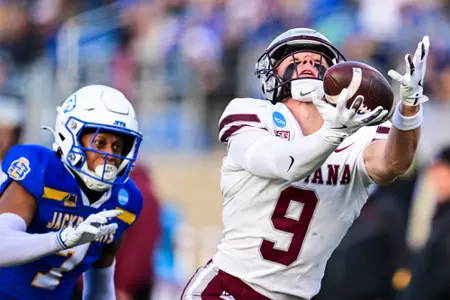 Hayden Harris #48 of the Montana Grizzlies tackles Kirby Vorhees #20 of the South Dakota State Jackrabbits during the fourth quarter at Dana J Dykhouse Stadium on December 7, 2024 in Brookings, South Dakota.