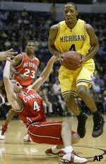 Mike O'Donnell tries to draw the charge on Michigan's Daniel Horton.