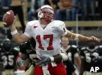 Quarterback Philip Rivers takes a shot from behind.