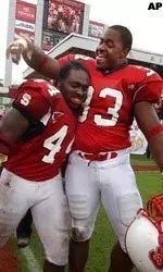 Running back T.A. McLendon (44) celebrates with defensive end Raymond Brooks following McLendon's game winning score on Saturday.