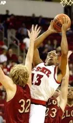 Cameron Bennerman drives between Elon's Chris Chalko (32) and Matt Nowlin (23) during the first half.