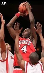 N.C. State forward Julius Hodge, center, shoots over St. John's Dexter Gray, left, and Daryll Hill during the first half.
