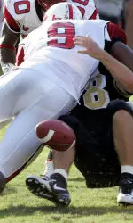 Wake Forest quarterback Benjamin Mauk loses the ball as he is tackled in the end zone by Mario Williams.