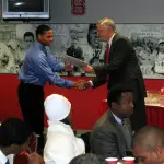 Jason St. Julien, a former baseball student-athlete and NC State Athletics Director Lee Fowler.