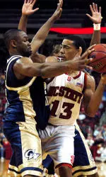 Cameron Bennerman struggles to protect the ball against George Washington University's Carl Elliott.
