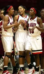 Ashley Key, Khadijah Whittington and Billie McDowell (from left to right) celebrate during the first half.