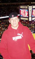 Contest winner Roger Pareja enjoys the game between N.C. State and Florida State.