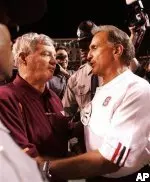 Virginia Tech's Frank Beamer and Chuck Amato of NC State meet after Sunday's game.