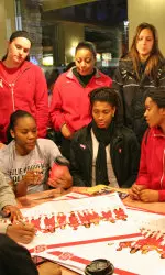 The Wolfpack women's basketball team signing autographs.