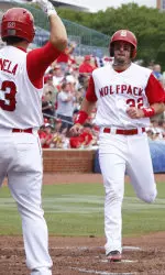 Tarran Senay is greeted at home plate by teammate Danny Canela.