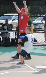Brett Williams celebrates as a member of the Miracle League White Sox scores a run.