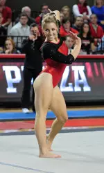 Senior Jess Panza performing a routine on floor