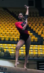 Diahanna Ham performing a routine on the balance beam