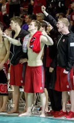 The team cheering on the sidelines at its dual meet versus UNC-Chapel Hill