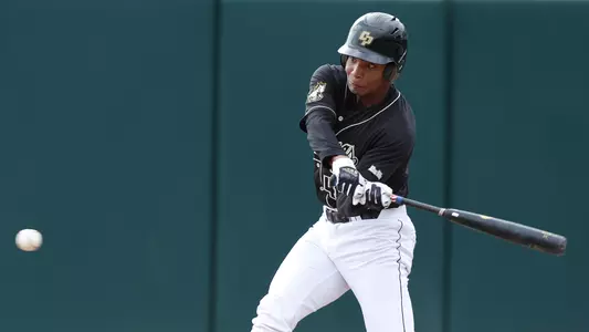 Elijah Greene swings a baseball bat.