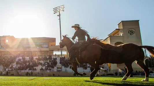 Chase sprinting onto football field at Cal Poly.