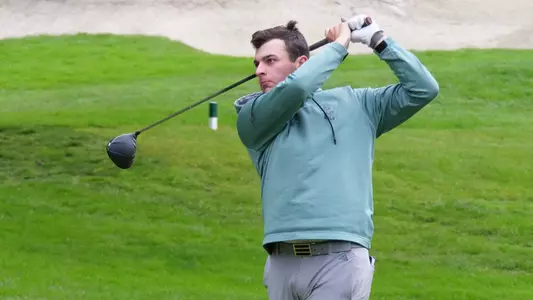 Luke Adam follows his tee shot.