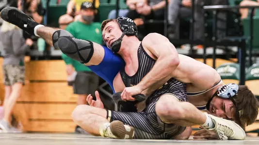 Lawrence Saenz wrestles an opponent from Air Force.