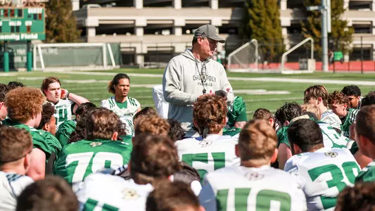 Paul Wulff chats with his team at the end of the first practice of Spring Camp.