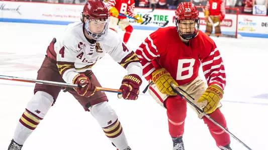 Wilmer Skoog skating next to a BC player