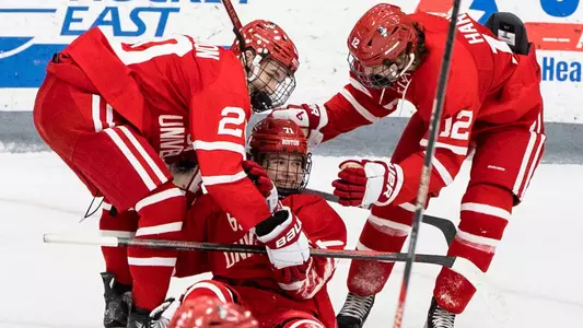 Lane Hutson and Jack Harvey celebrate with a smiling Macklin Celebrini after Celebrini scored at Providence