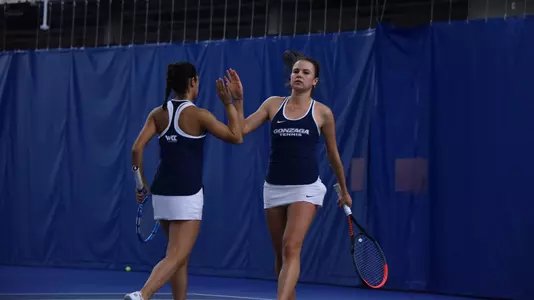 Vlada Medvedcova and Kate Ketels high-five after a point