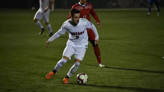 Theo O'Malley dribbles past defender