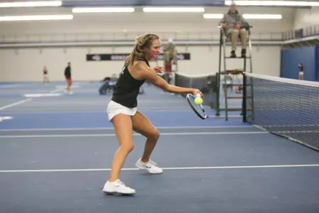 Sara Komer hits a forehand during doubles