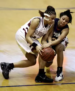 Fordham's Monica Mack, left, and Dayton's Terri Ramsey compete for the ball during the second half of an Atlantic 10 tournament game Friday in Washington.