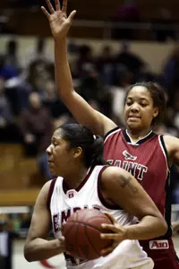 Temple's Landy Comfort, left, drives to the basket while being guarded by Saint Joseph's' Erica Pollock in the first half Saturday in Washington.