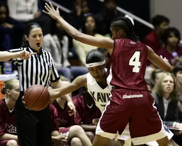 Xavier's Michele Miller, center, tries to move around the defense of Massachusetts' Brooke Campbell during the first half.