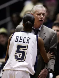George Washington's Kimberly Beck, left, restrains coach Joe McKeown as he yells at Fordham coach Jim Lewis during the first half.