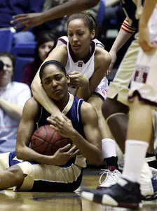 George Washington's Whiteny Allen, front, and Temple's Ari Moore go after a loose ball during the first half of the Atlantic 10 championship game.