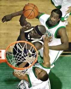 Pops Mensah-Bonsu of George Washington is fouled by Marshall's LaVar Carter as he goes up for a shot in the second half. (AP Photo/Jeff Gentner)