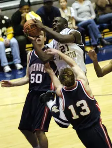 Pops Mensah-Bonsu drives to the basket against Richmond's Peter Thomas (13) and Drew Crank (50) during the first half. (AP Photo/Nick Wass)