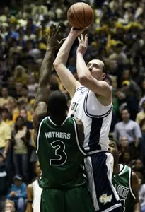 Charlotte's Curtis Withers (3) defends George Washington's Alex Kireev, right, of the Ukraine, during the first half Saturday. (AP Photo/Evan Vucci)