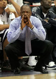 George Washington coach Karl Hobbs shouts instructions to his players during the first half against Temple on Thursday. (AP Photo/Tom Uhlman)