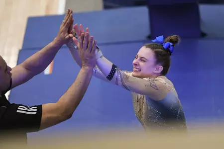 Warhol high fives after vault routine.