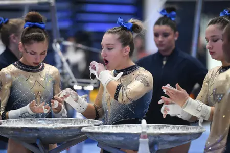 Banen prepares her grips for bars.