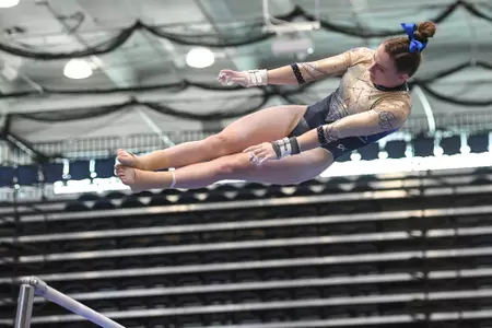 Warhol competes on uneven bars.