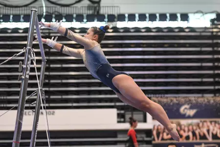 Karpova competes on uneven bars.