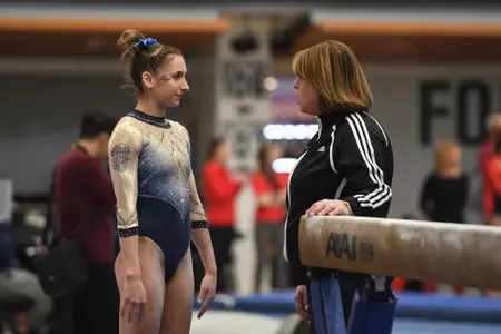 Zona competes on beam.