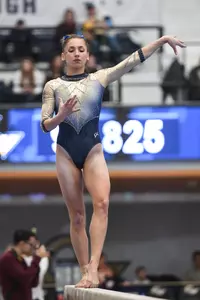 Zona competes on beam.
