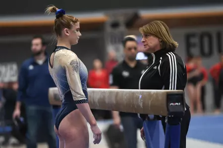 Raymond and Foster-Cunningham talk before competing on beam.