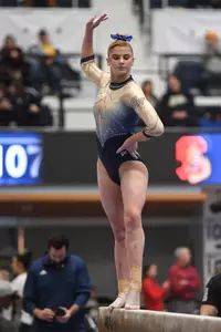 Raymond competes on beam.