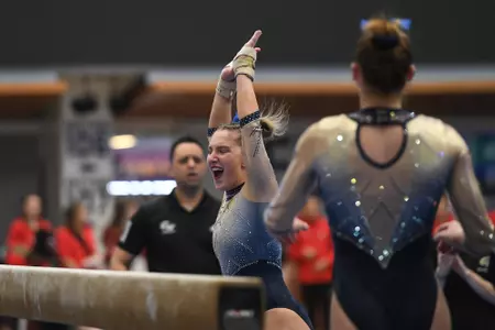 Banen celebrates after competing on beam.